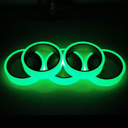 Glow in the dark sticker tape roll glowing in low light, used for home decor, stairs, and DIY crafts.

