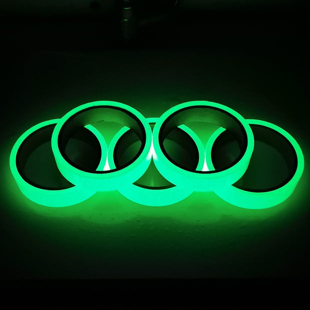 Glow in the dark sticker tape roll glowing in low light, used for home decor, stairs, and DIY crafts.

